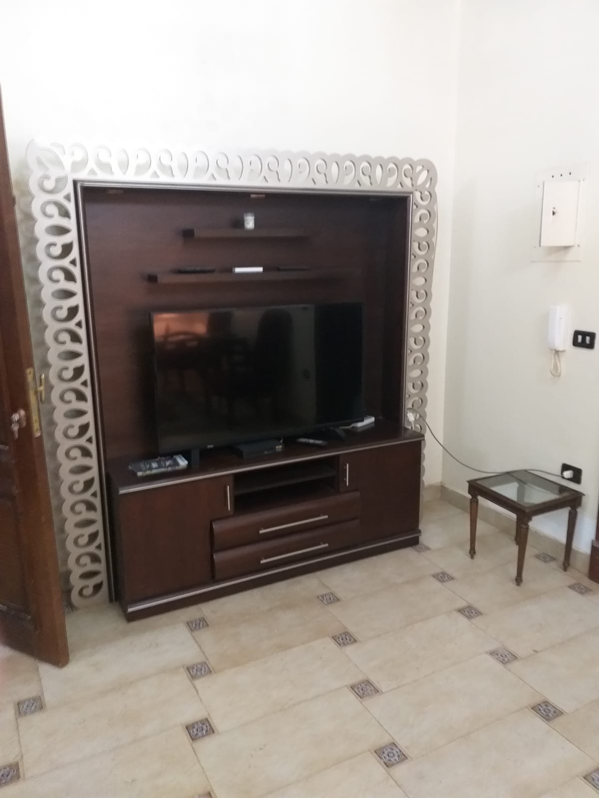 TV unit with a decorative frame beside a side table - apartment in Yasmeen 3, New Cairo