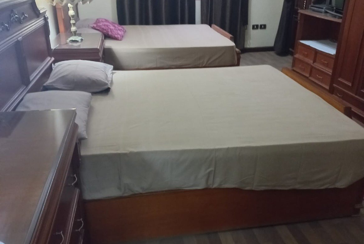 Bedroom with a grey bed cover and a window - apartment in Yasmeen 3, New Cairo