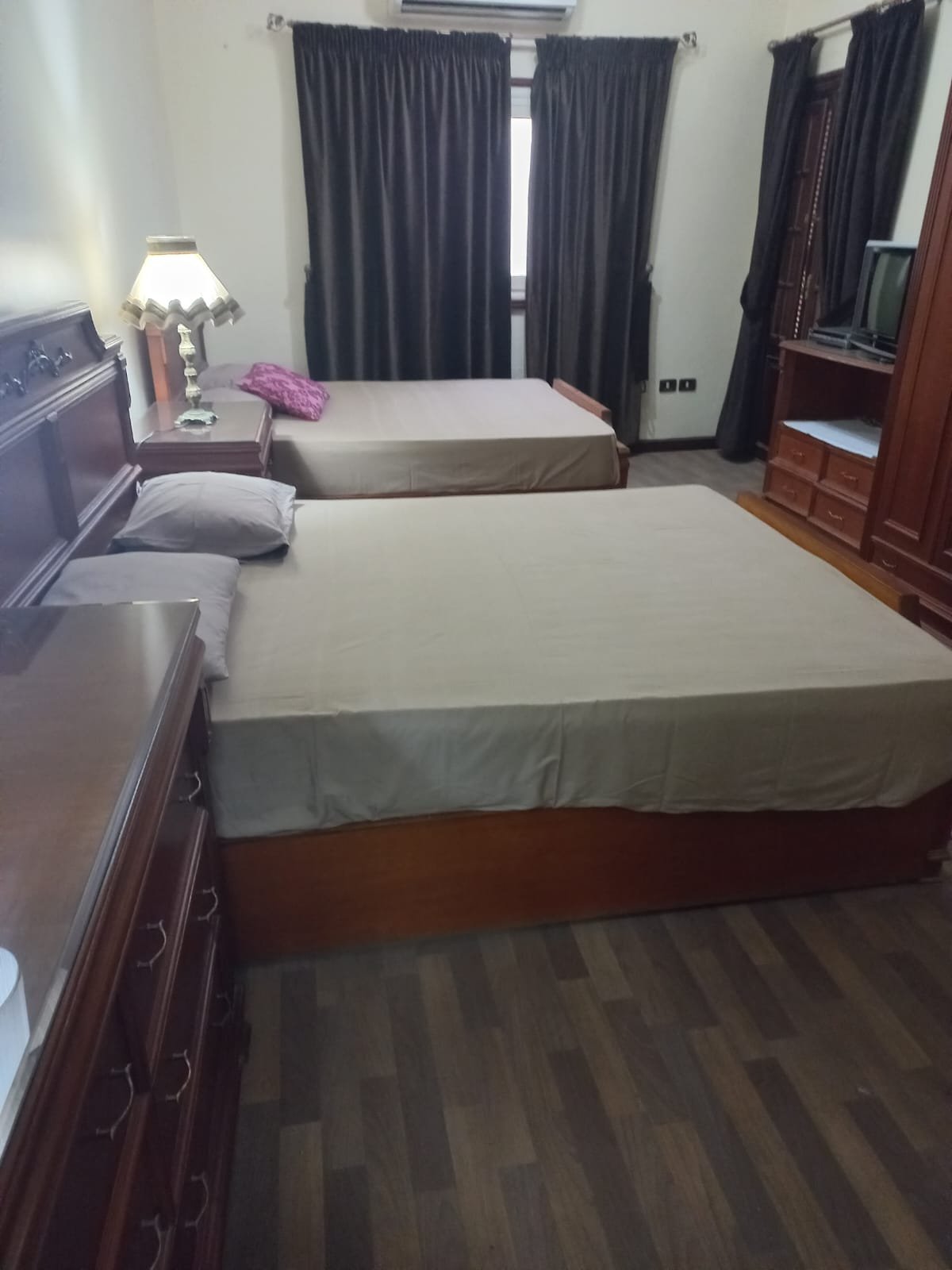 Bedroom with a grey bed cover and a window - apartment in Yasmeen 3, New Cairo