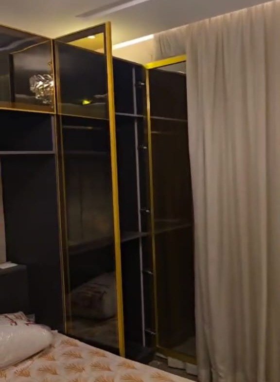 Bedroom with a dark fitted wardrobe - apartment in Taj City, New Cairo