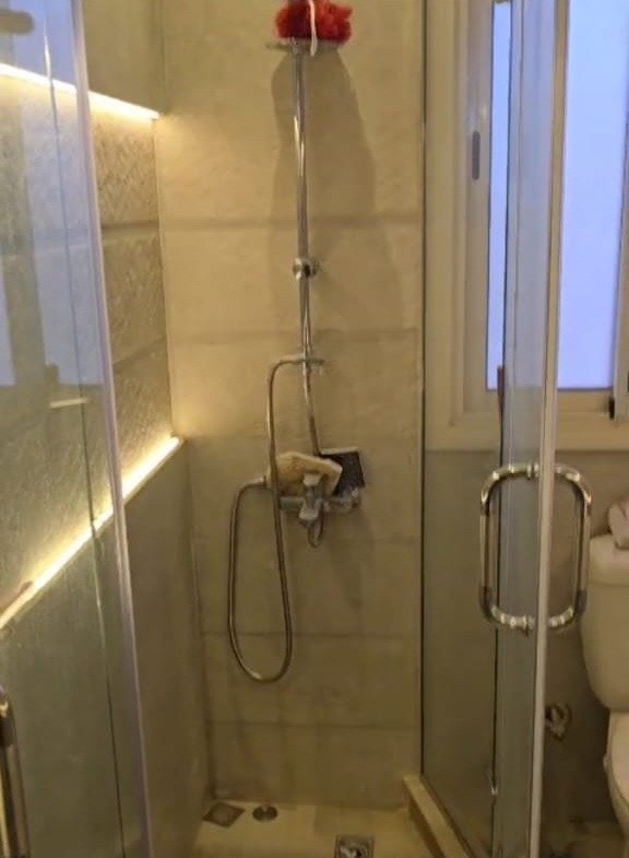 Bathroom with a glass shower enclosure - apartment in Taj City, New Cairo