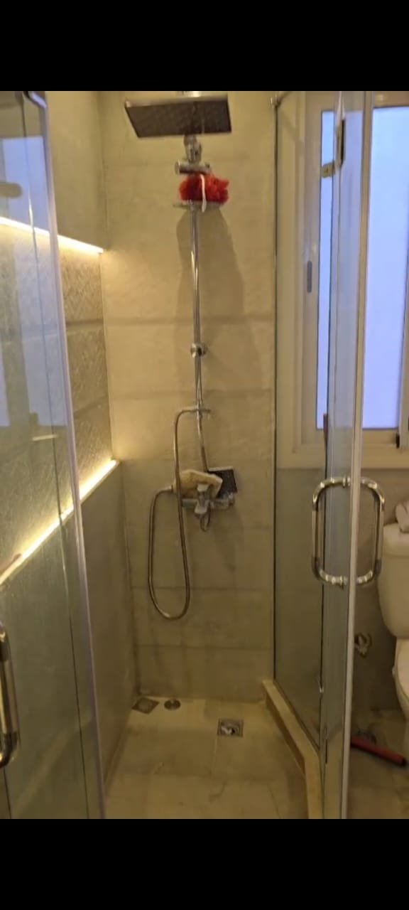 apartment-sale-taj-city-zone-t-36-shower Bathroom with a glass shower enclosure - apartment in Taj City, New Cairo