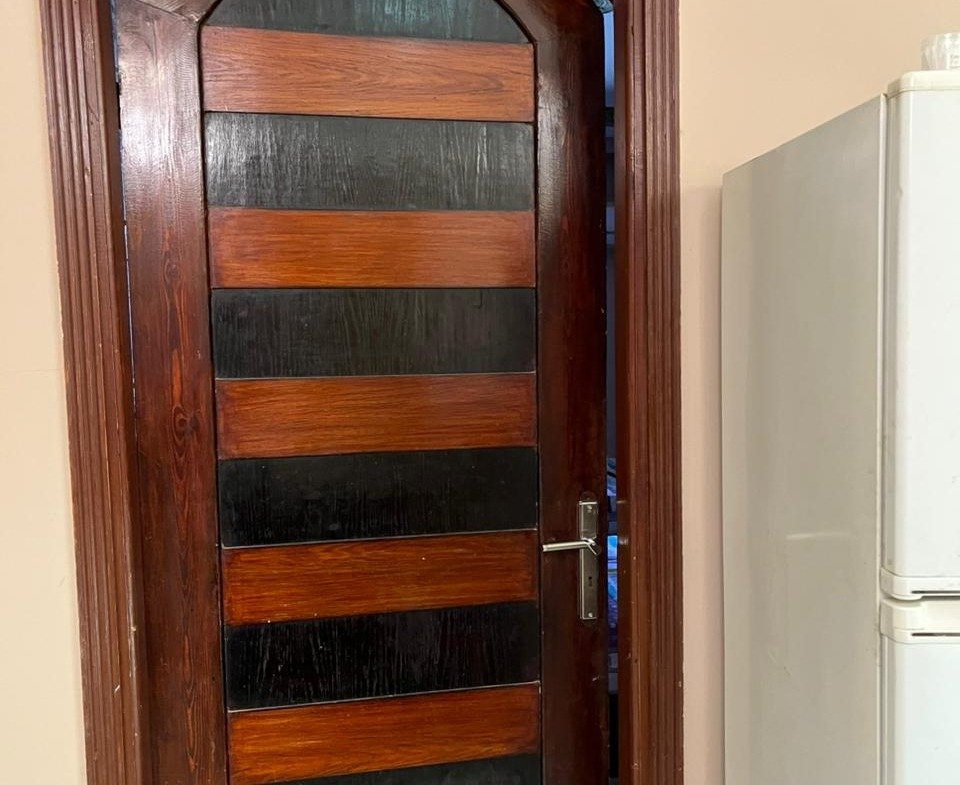 Arched wooden door with glass panels - apartment in Banafseg Buildings, New Cairo