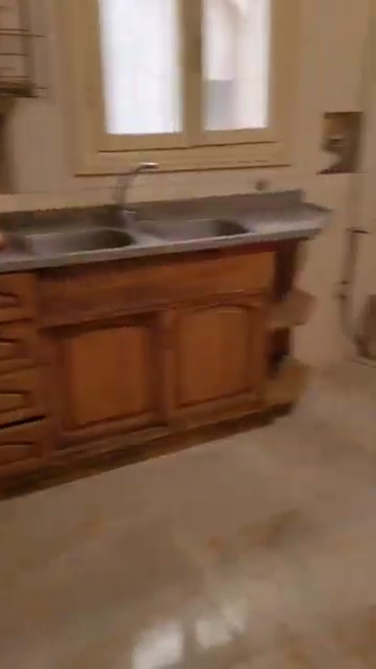 Kitchen with a wooden base unit and double sink - apartment in Al Banafseg New Cairo – 3 Bedrooms 220 sqm Mohamed Naguib St, New Cairo