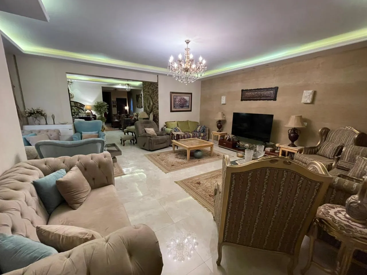 banafseg10-apt-201-2 Large living room with cream sofas and a chandelier - apartment in Al Banafseg 10, New Cairo