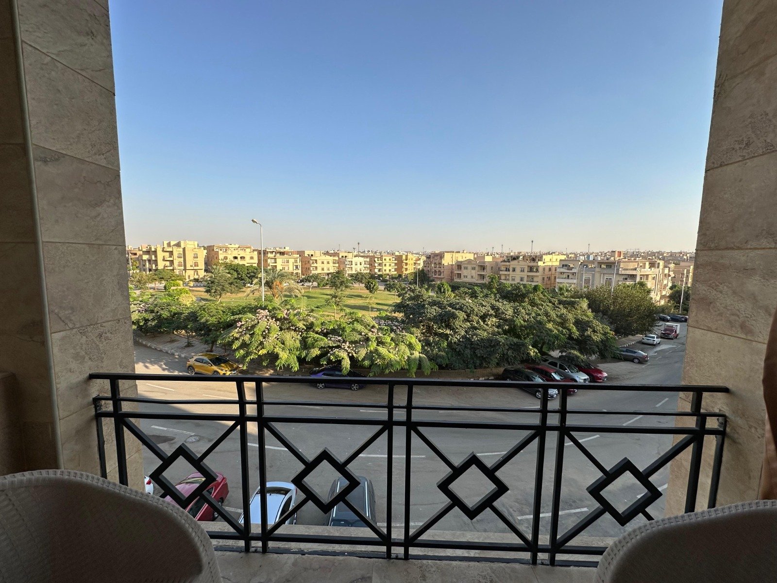 banafseg10-apt-201-3 Balcony with diamond-pattern railing and a view of the greenery - apartment in Al Banafseg 10, New Cairo