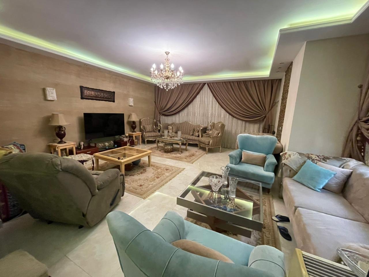 banafseg10-apt-201-4 Living area with teal armchairs and green ceiling lighting - apartment in Al Banafseg 10, New Cairo