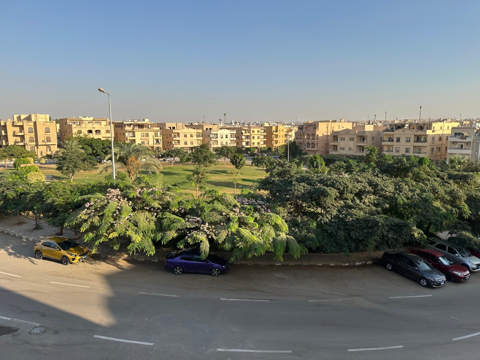 banafseg10-apt-201-7 Parked cars and tree-filled garden seen from the apartment - apartment in Al Banafseg 10, New Cairo
