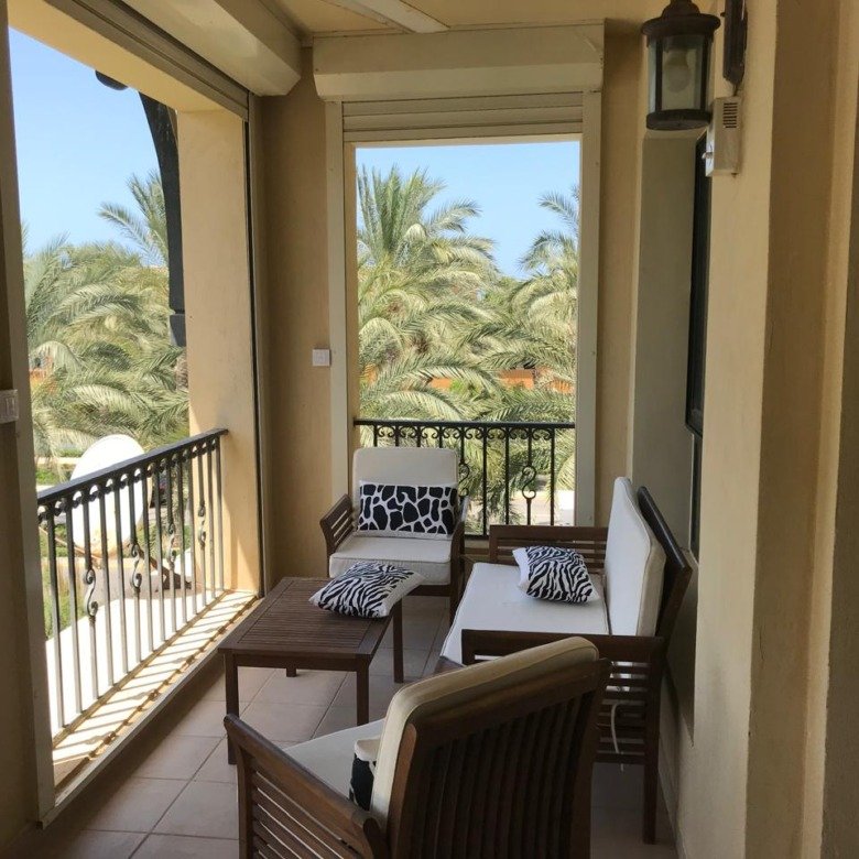 Furnished chalet for sale in Catania Marassi North Coast - balcony with pool and palm view