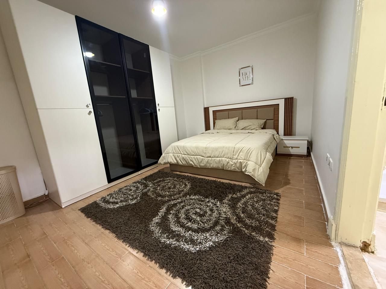 dar-misr-koronfol-apt-rent-097-07 Bedroom with a black-glass wardrobe and a patterned rug - apartment in Dar Misr Al Koronfol New Cairo – 3 Bedrooms 130 sqm, New Cairo