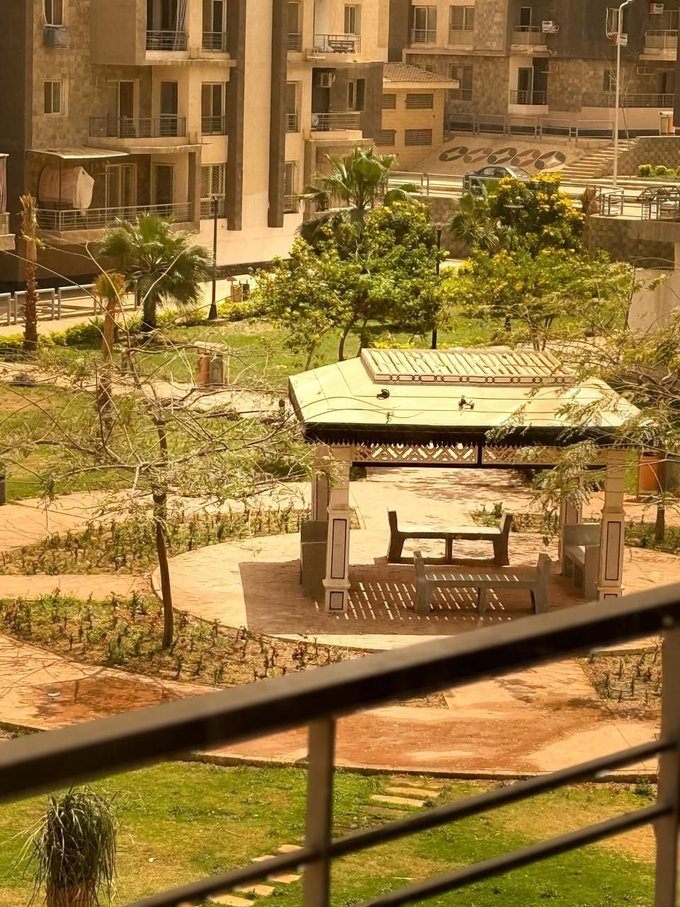 dar-misr-koronfol-apt-rent-097-10 Gazebo and landscaped garden viewed from a terrace - apartment in Dar Misr Al Koronfol New Cairo – 3 Bedrooms 130 sqm, New Cairo