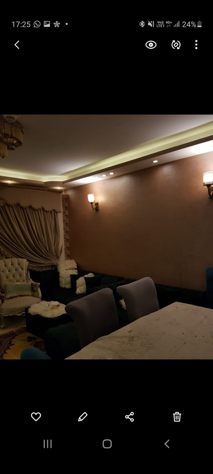 Dim bedroom corner with a dark bed and warm lamps - duplex in Porto, New Cairo