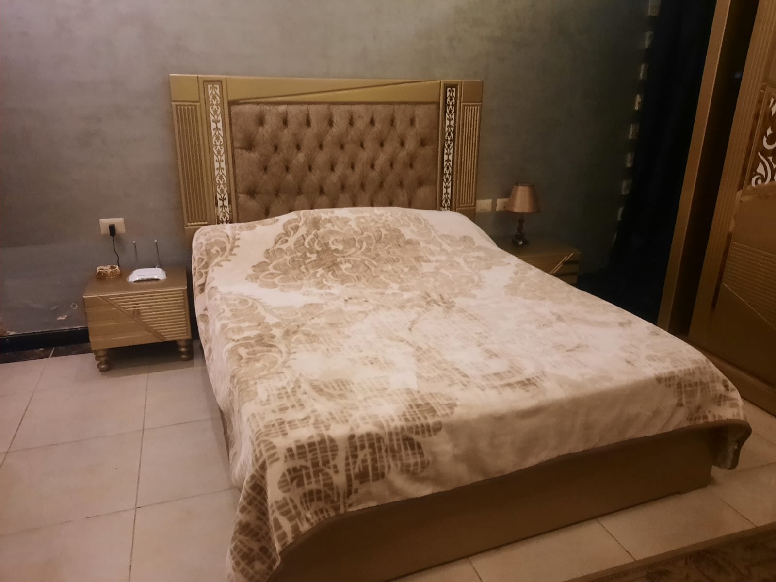 Bedroom with a quilted headboard and a patterned bed cover - duplex in Porto, New Cairo