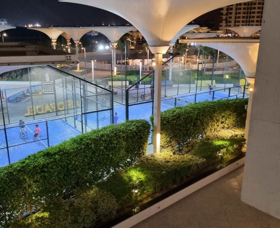 Evening view of a courtyard with a pool and a canopy - duplex in Porto, New Cairo
