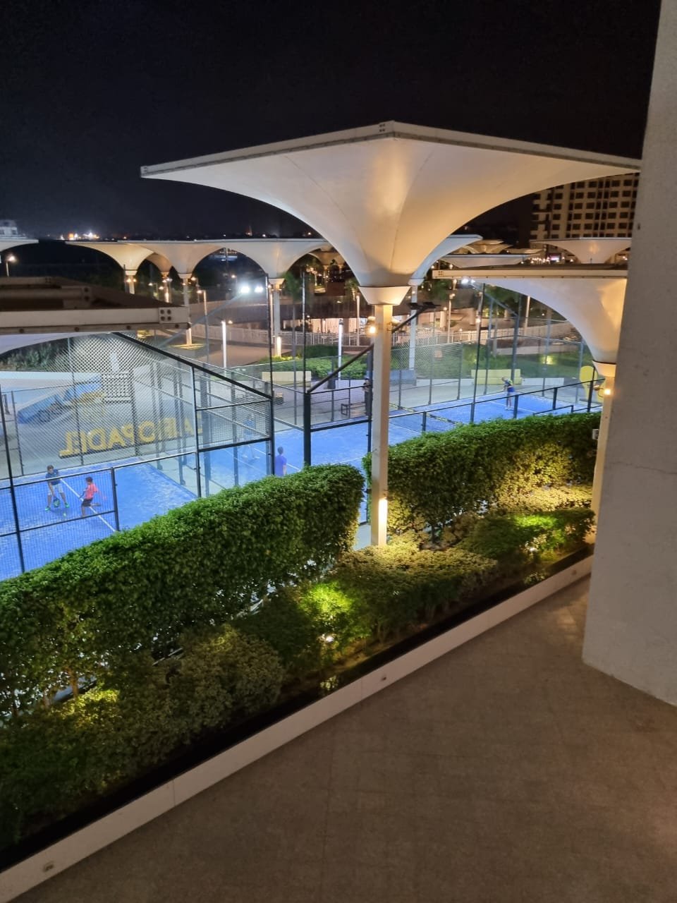 Evening view of a courtyard with a pool and a canopy - duplex in Porto, New Cairo