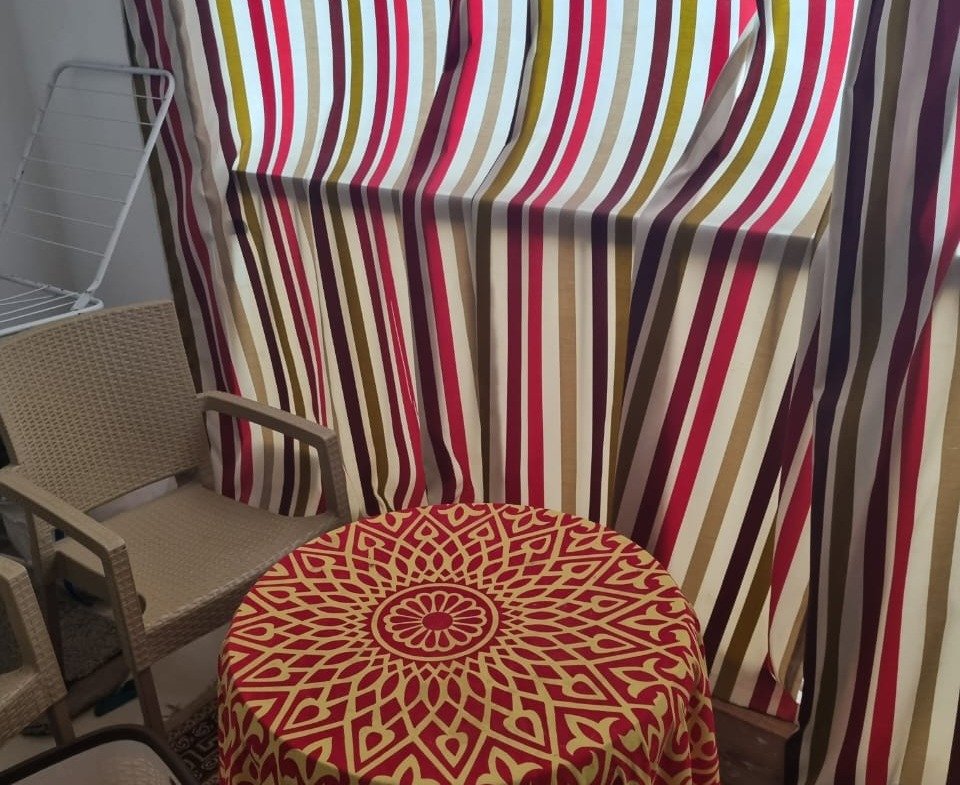 Balcony corner with a striped awning and a small table - duplex in Porto, New Cairo