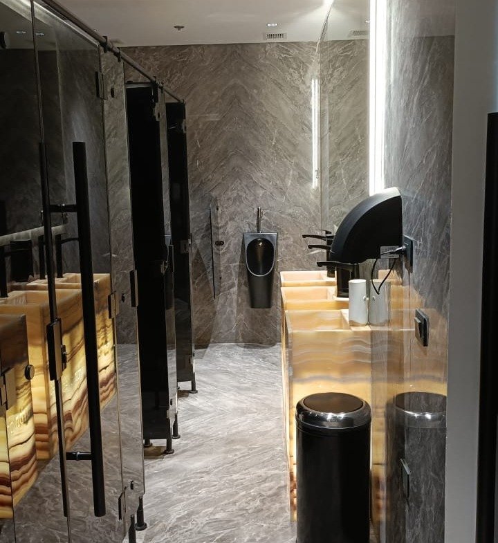 Restroom corridor with a stone floor and a lit counter at the end - unit in Marassi