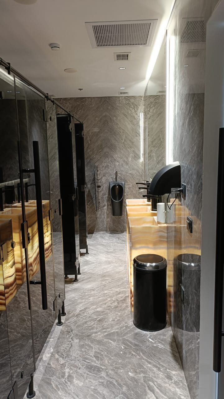 Restroom corridor with a stone floor and a lit counter at the end - unit in Marassi