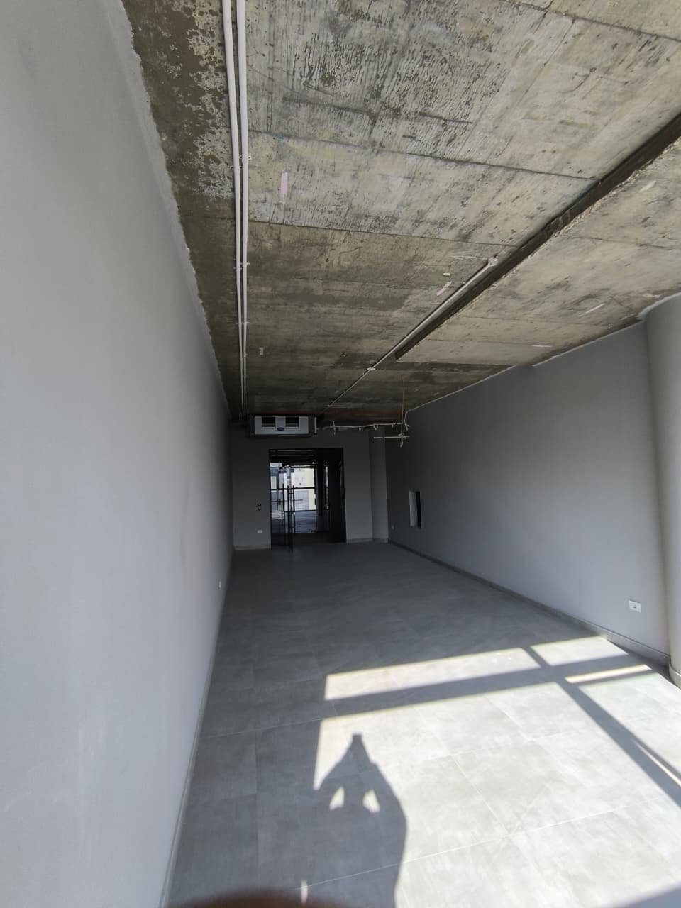 Narrow shell space looking toward a far window - unit in Marassi