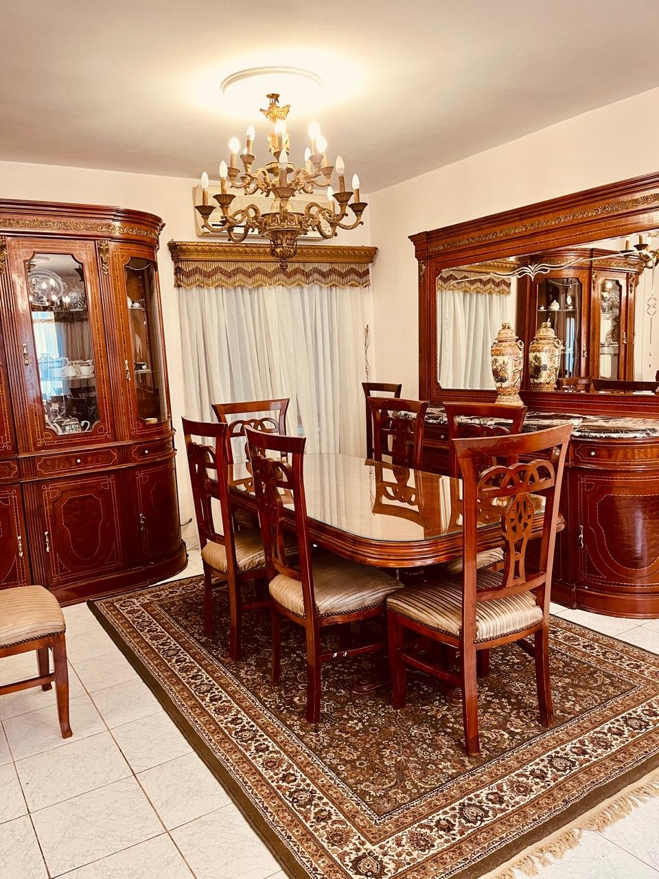 el-rehab-apt-rent-108-04 Dining room with a sideboard mirror and patterned rug - apartment in El Rehab New Cairo – 3 Bedrooms 183 sqm – Garden View, New Cairo
