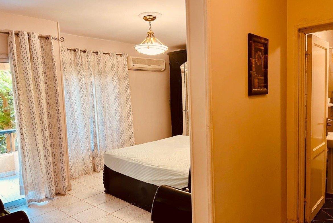 Bedroom with a ceiling lamp and long curtains - apartment in El Rehab New Cairo – 3 Bedrooms 183 sqm – Garden View, New Cairo