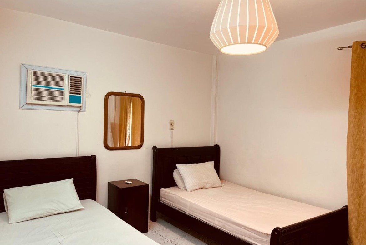 Twin beds with dark frames and a wall AC - apartment in El Rehab New Cairo – 3 Bedrooms 183 sqm – Garden View, New Cairo