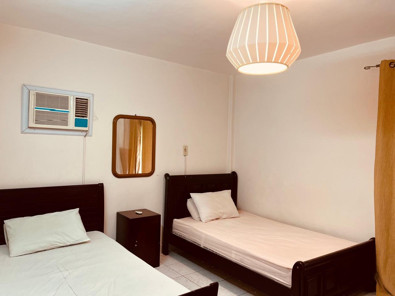 el-rehab-apt-rent-108-06 Twin beds with dark frames and a wall AC - apartment in El Rehab New Cairo – 3 Bedrooms 183 sqm – Garden View, New Cairo