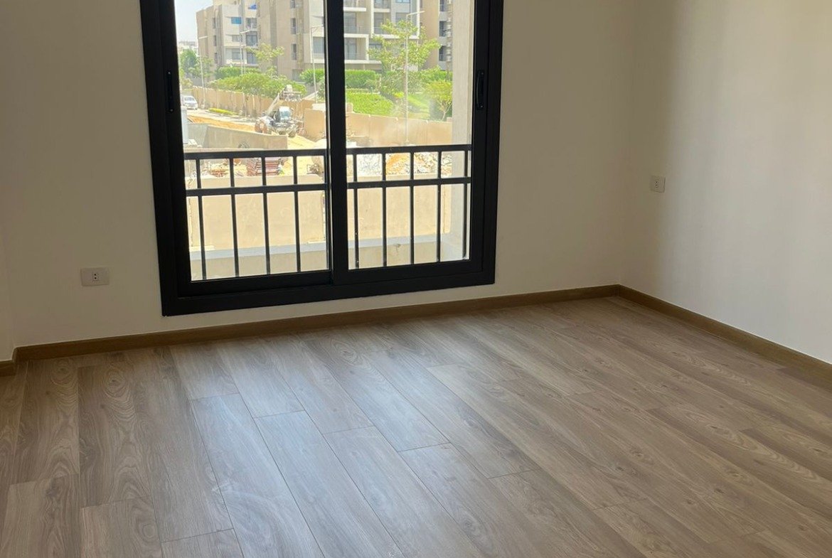 Empty bedroom with window and wooden floor - apartment in Fifth Square, New Cairo