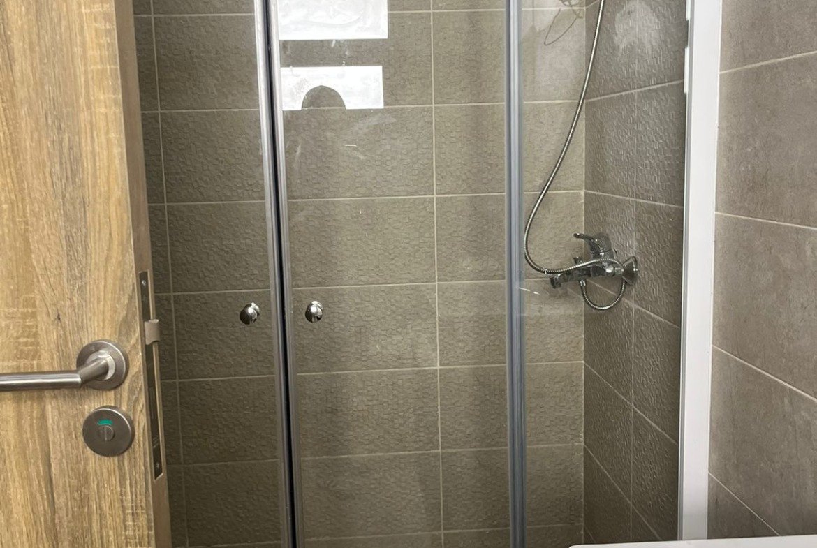 Bathroom with glass shower and washbasin - apartment in Fifth Square, New Cairo