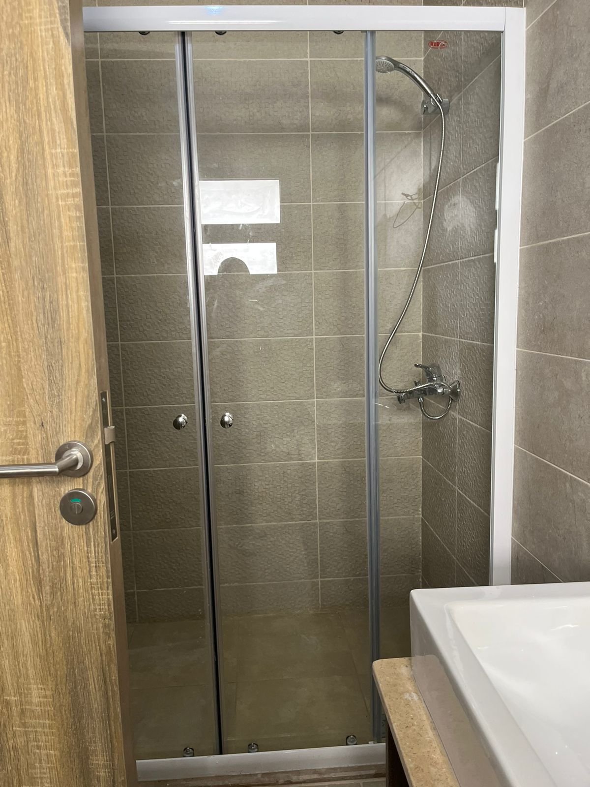Bathroom with glass shower and washbasin - apartment in Fifth Square, New Cairo