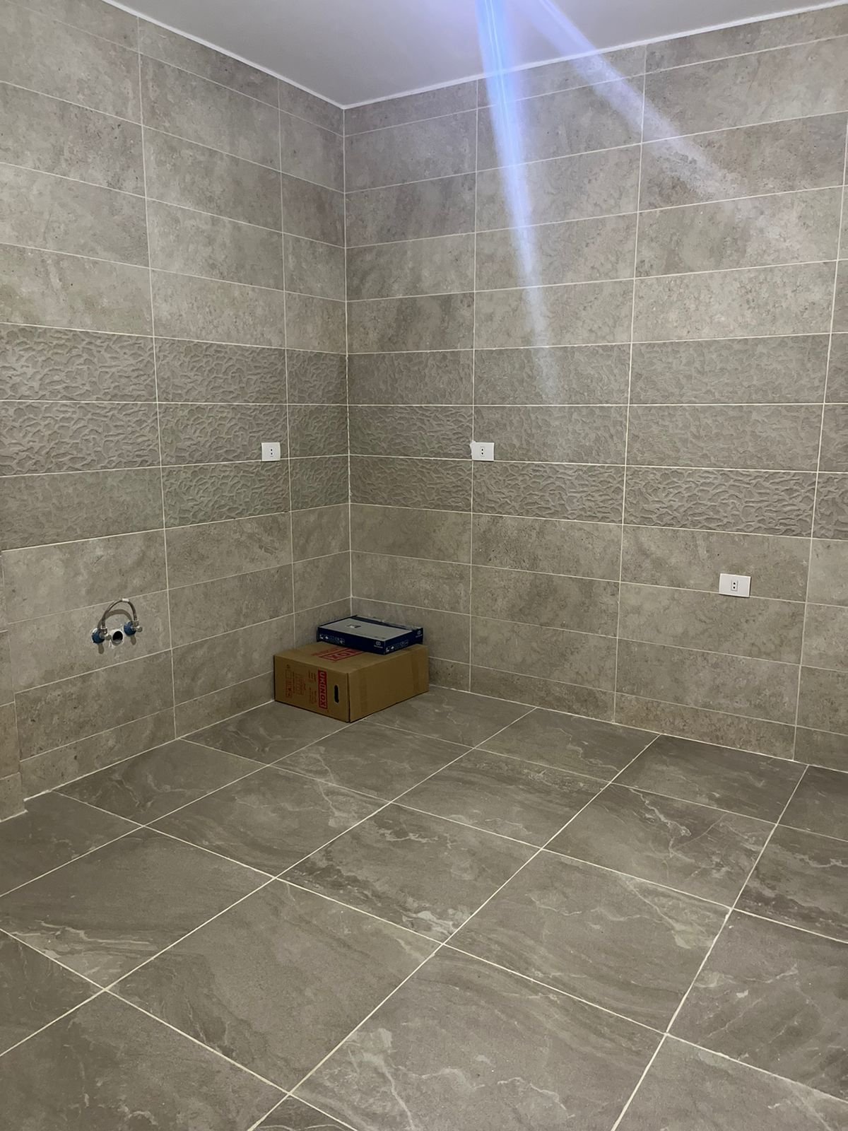Empty bathroom with grey tiles - apartment in Fifth Square, New Cairo