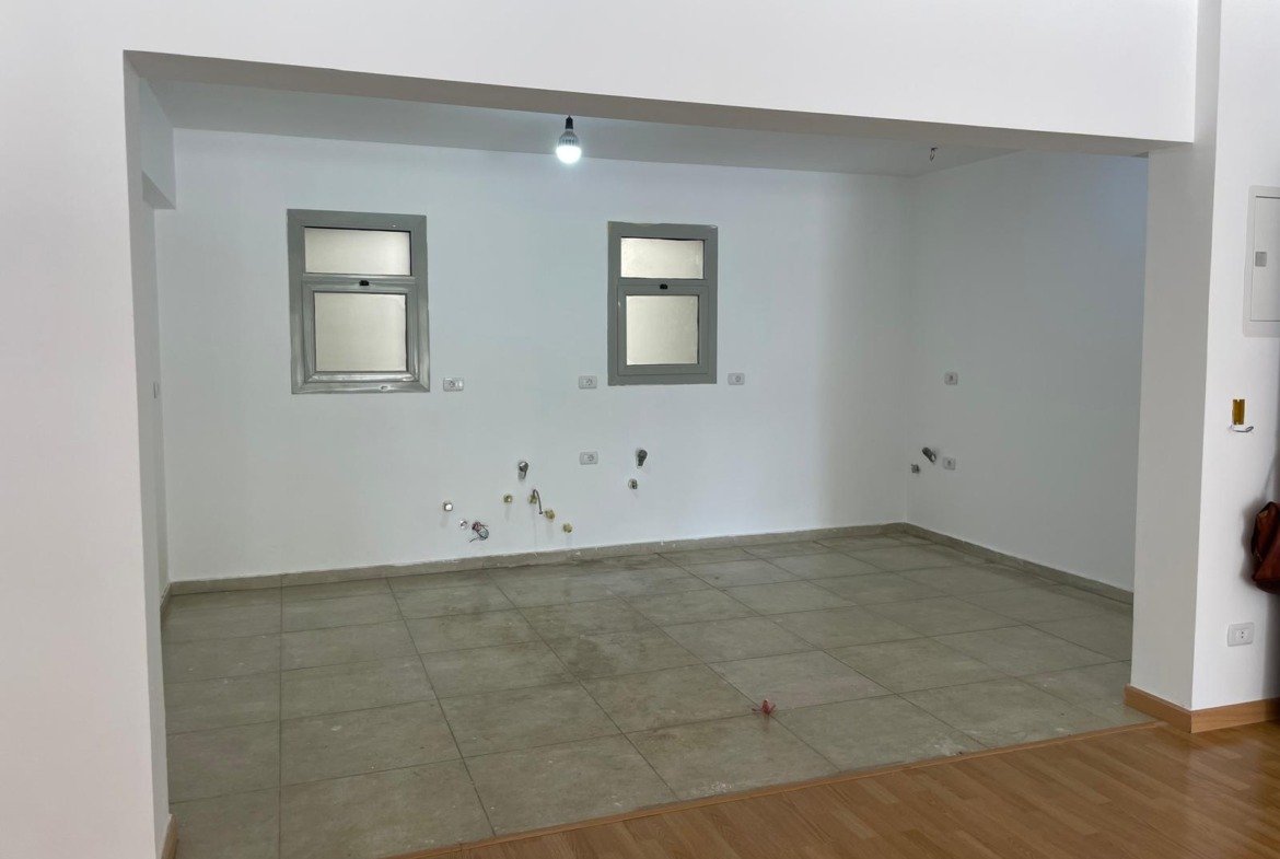 Empty kitchen space with two small windows and plumbing outlets - apartment in Capital Gardens Next to Madinaty, Mostaqbal City