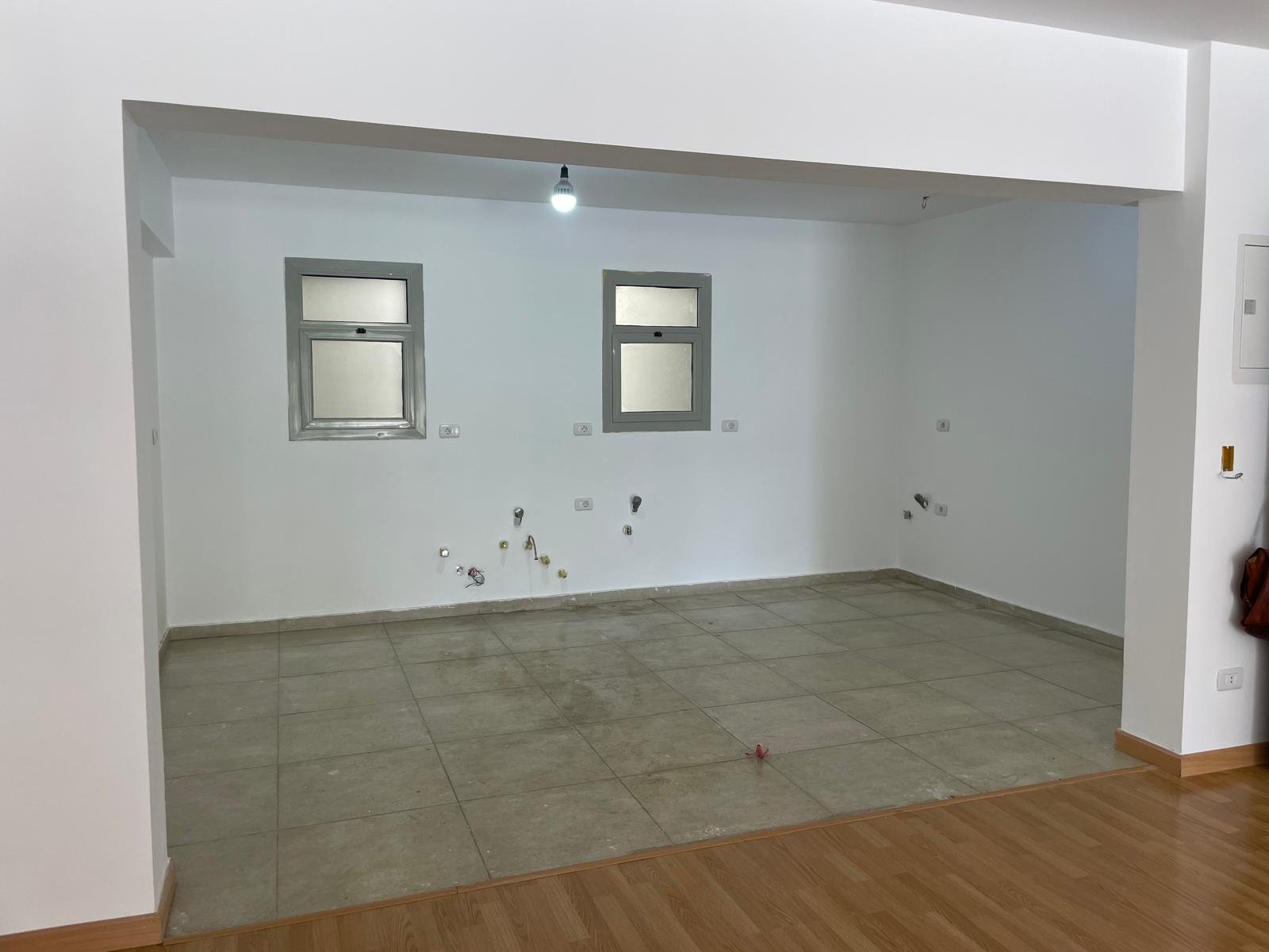 Empty kitchen space with two small windows and plumbing outlets - apartment in Capital Gardens Next to Madinaty, Mostaqbal City