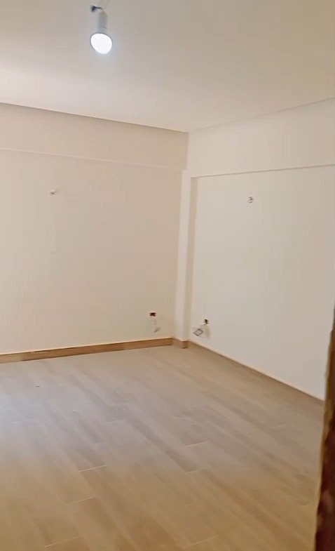 Empty room with laminate flooring and white walls - apartment in Mountain View iCity, New Cairo