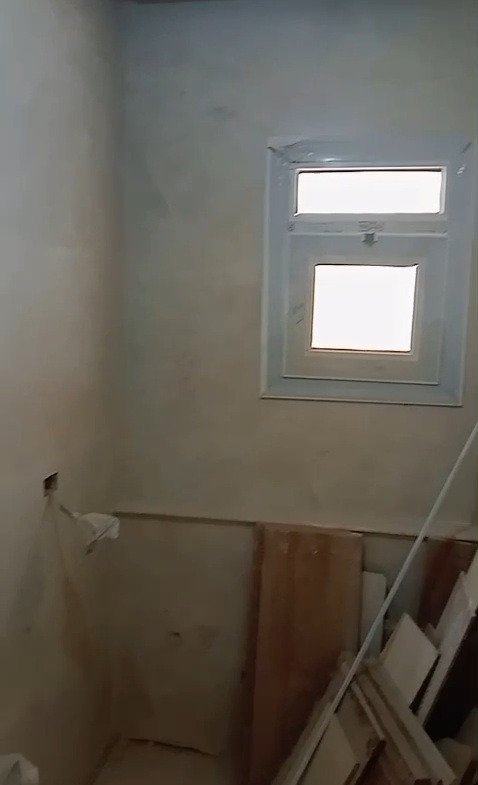 Shower cabin with a small frosted window - apartment in Mountain View iCity, New Cairo