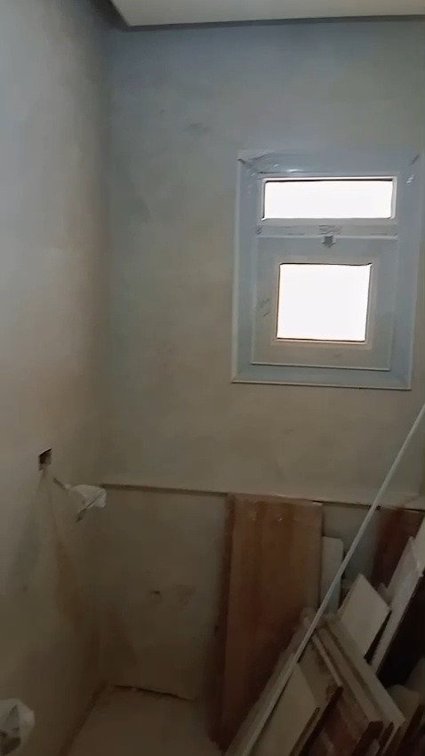 Shower cabin with a small frosted window - apartment in Mountain View iCity, New Cairo