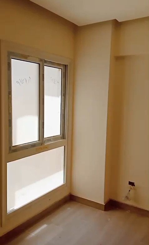 Window with wooden frame in an empty room - apartment in Mountain View iCity, New Cairo