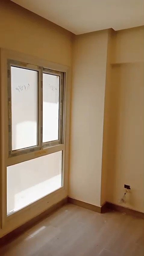 Window with wooden frame in an empty room - apartment in Mountain View iCity, New Cairo
