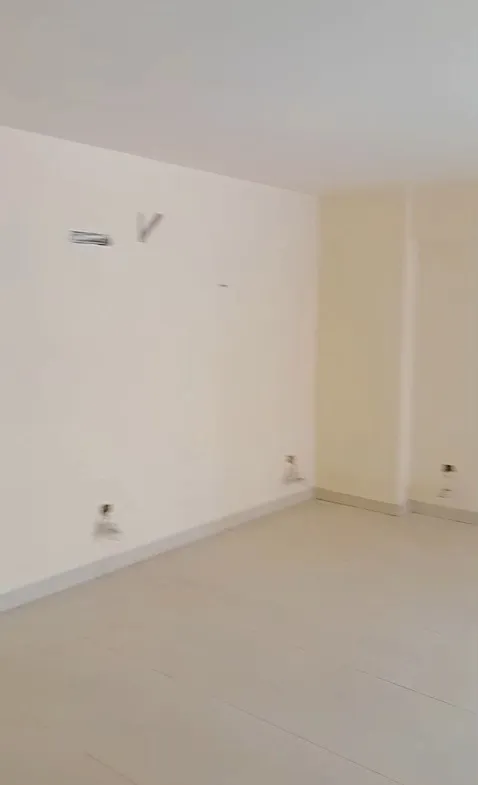 Empty room with plain white walls and light tiles - apartment in Mountain View iCity, New Cairo