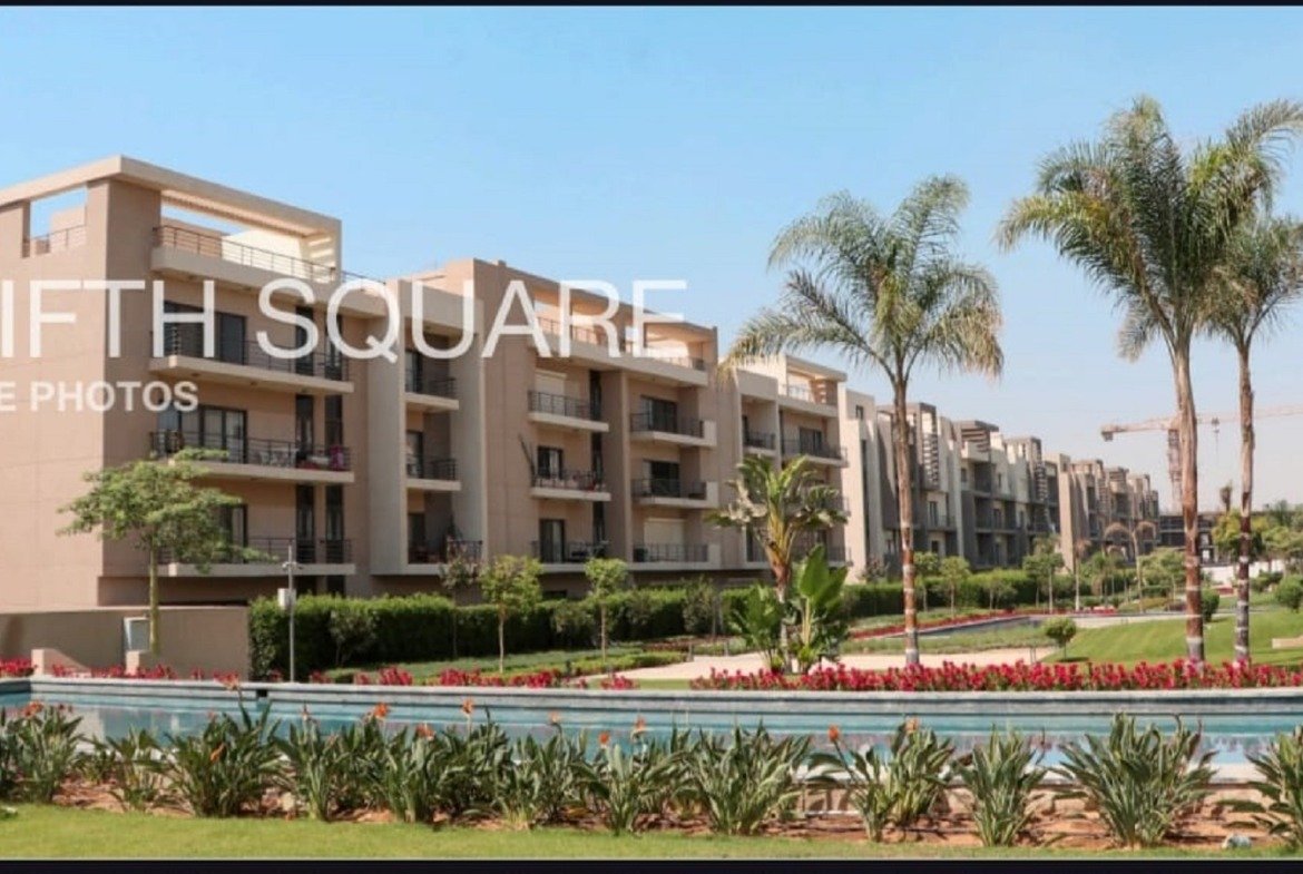 Palm trees and pool beside the apartment buildings - apartment in Fifth Square, New Cairo