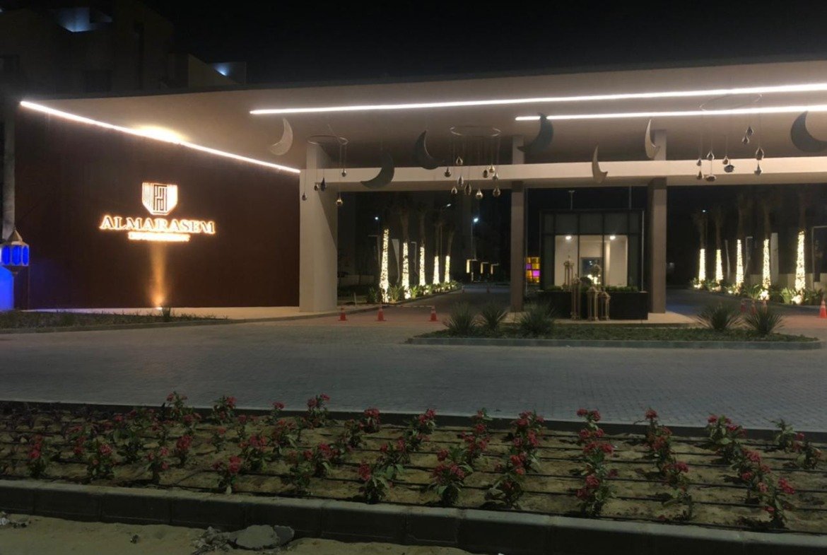 Compound entrance lit at night - apartment in Fifth Square, New Cairo