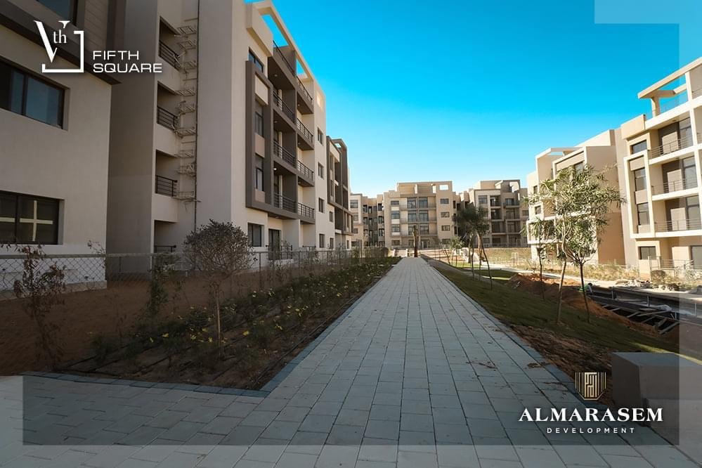 Paved walkway between planted beds - apartment in Fifth Square, New Cairo