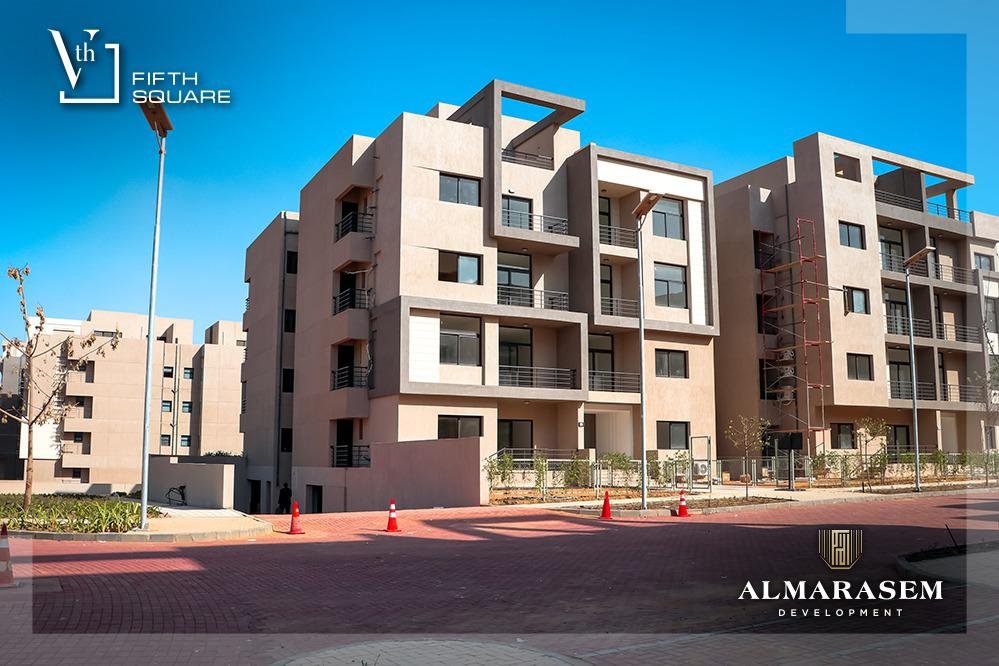Apartment buildings beside the compound street - apartment in Fifth Square, New Cairo