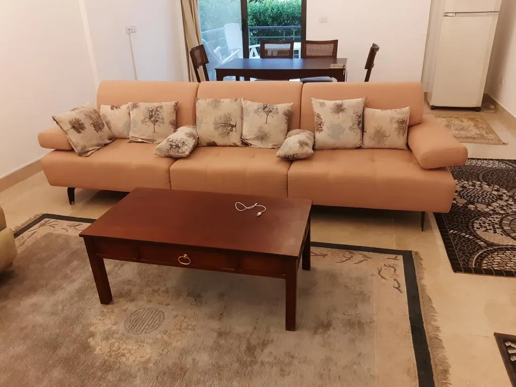 Furnished living room with orange sofa - apartment in Fifth Square, New Cairo