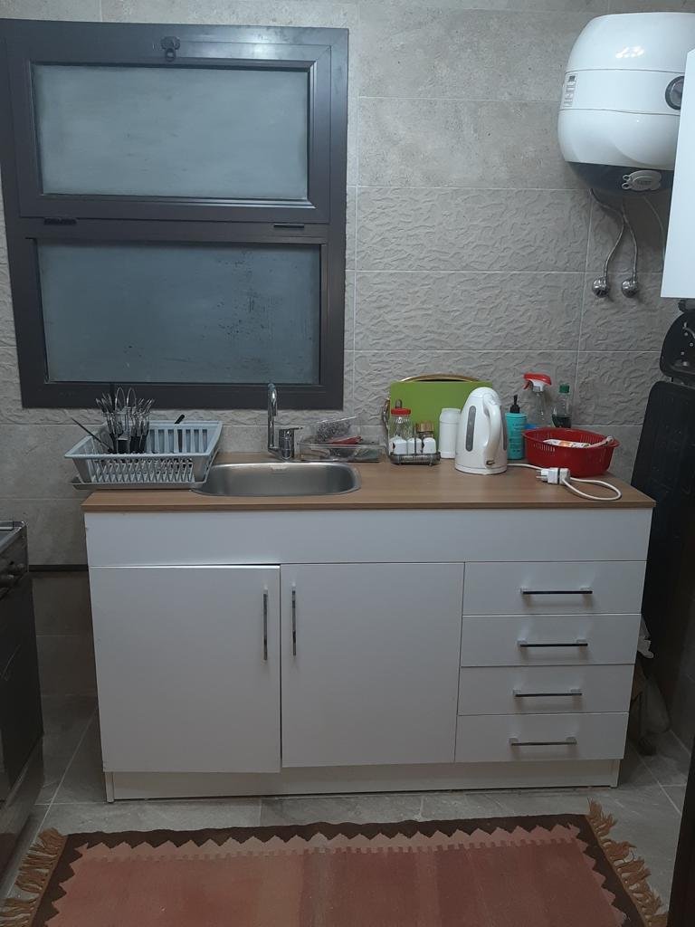 Kitchenette with sink and white cabinets - apartment in Fifth Square, New Cairo