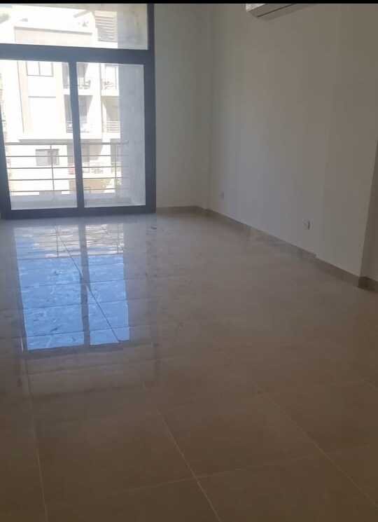 Empty reception with balcony door - apartment in Fifth Square, New Cairo