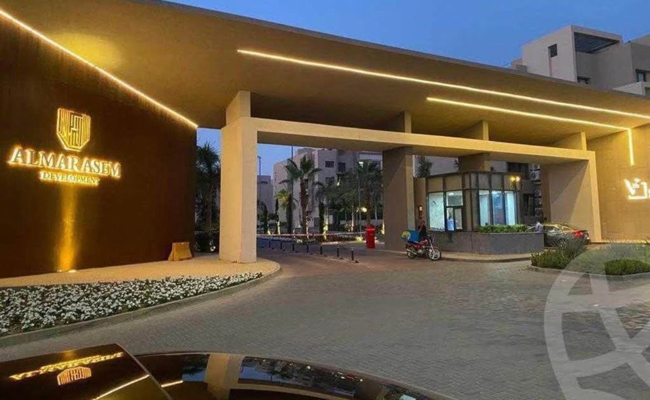 fifth-square-apt-198-3 Al Marasem compound entrance gate at dusk - apartment in Fifth Square, New Cairo