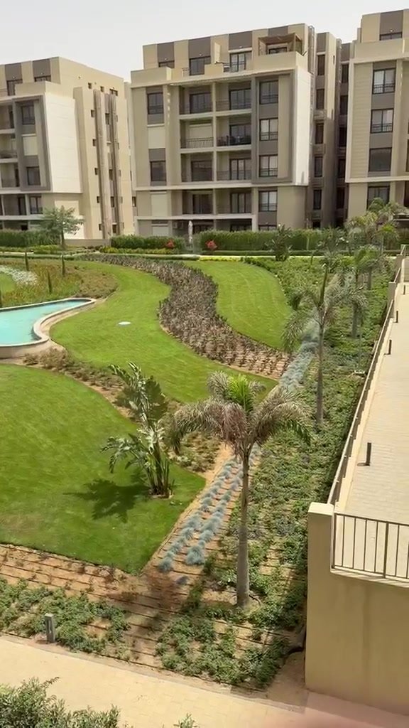 Landscaped garden and pool seen from the terrace - penthouse in Fifth Square, New Cairo