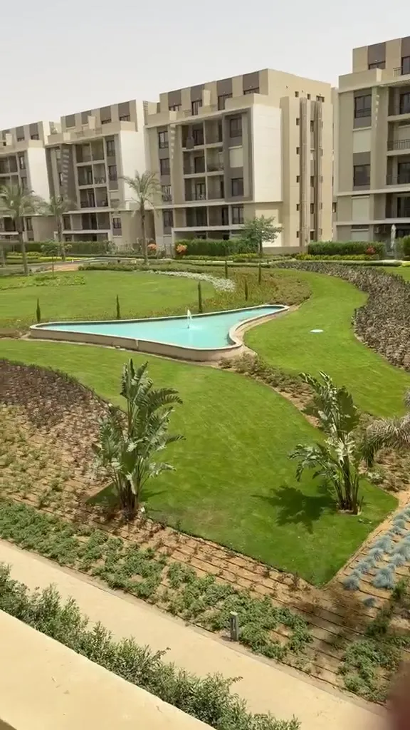 Garden and pool between the buildings - penthouse in Fifth Square, New Cairo