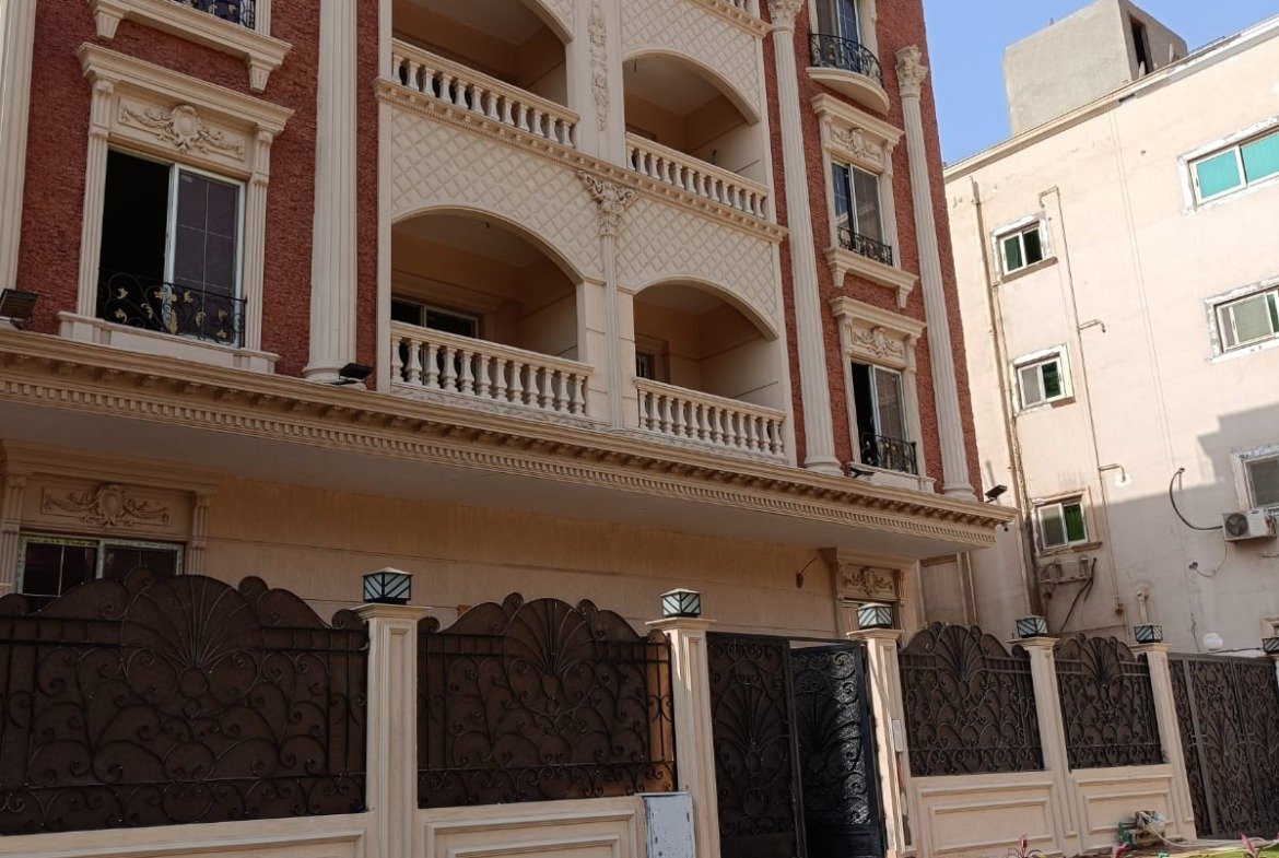 Pink-stone apartment building with a lawn in front - apartment in Gharb Arabella, 5th Settlement
